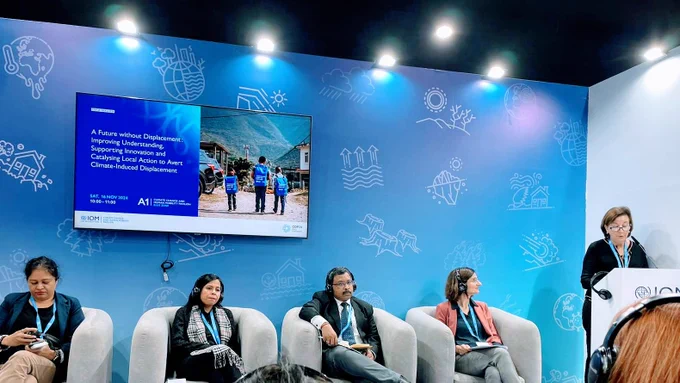 PRM Acting Assistant Secretary Marta Youth speaks at a podium next to seated panelists.