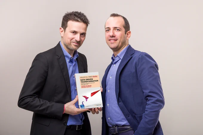 Andrea De Mauro and Michele Pacifico showing their latest book: The Financial Times Guide to Data-Driven Transformation. Maximise Business Value with Data Analytics.