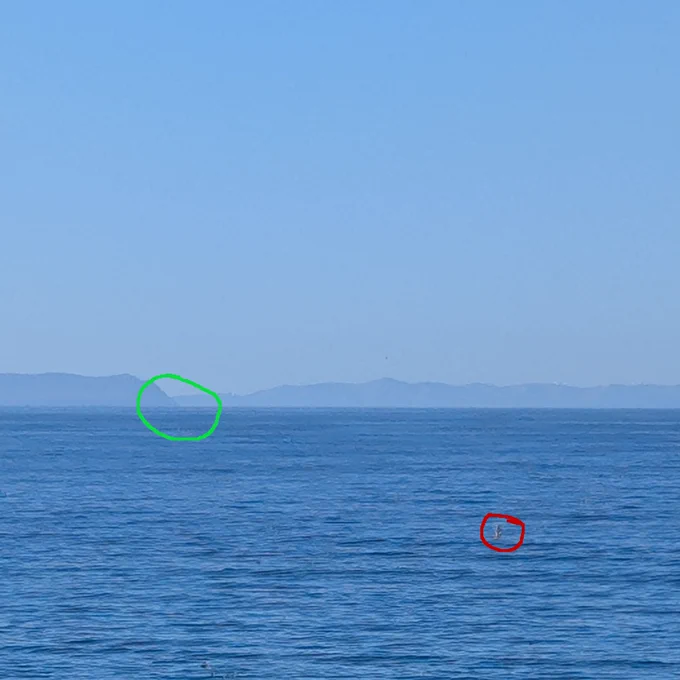 Photo 1, about 50 ft of elevation. the target of my photo is circled in green, the red circle is around a buoy that can also be seen in photo 2