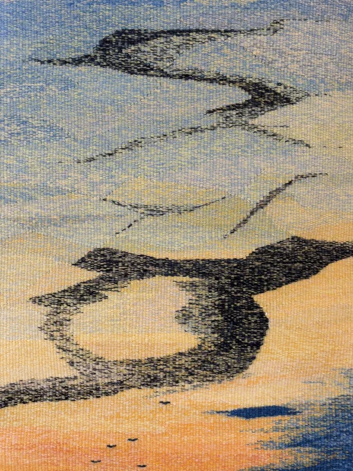 Tapestry of a murmuration of birds. Blue and orange sky background