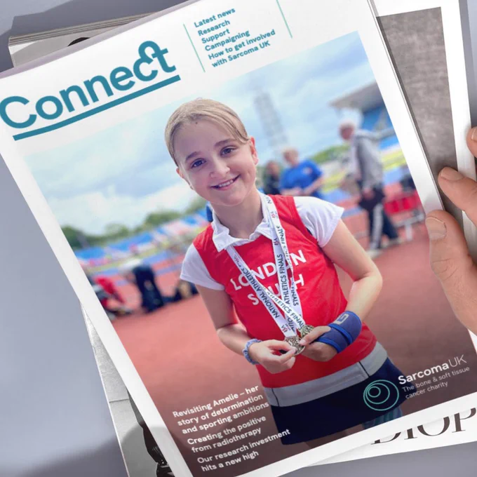 Photo shows Connect Magazine on the top of a pile of magazines. A photo of Amelie is on the front cover.