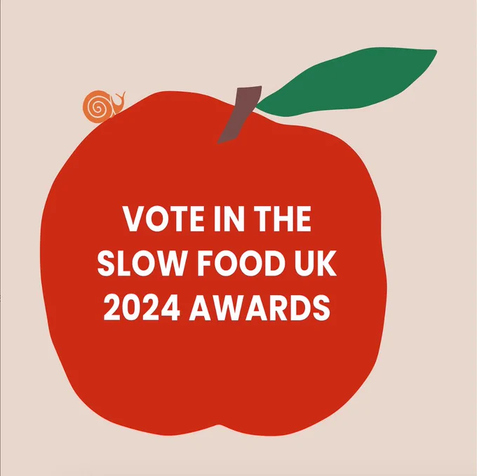 Red apple image with orange Slow Food snail logo and text within the apple stating "Vote in the Slow Food UK 2024 Awards".