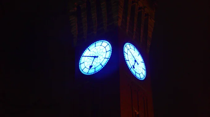The Old Joe clock tower, with the clock face lit up blue.