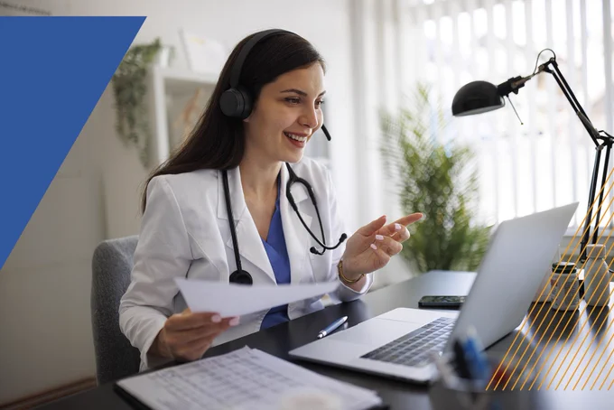Doctor talking into computer.