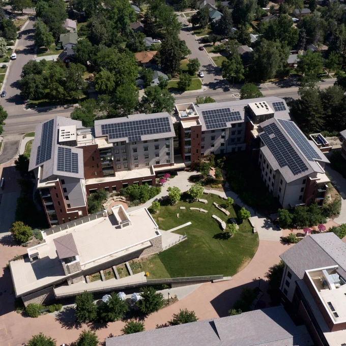 An aerial shot of buildings on the C S U campus. Solar panels are installed on the roofs of the building.