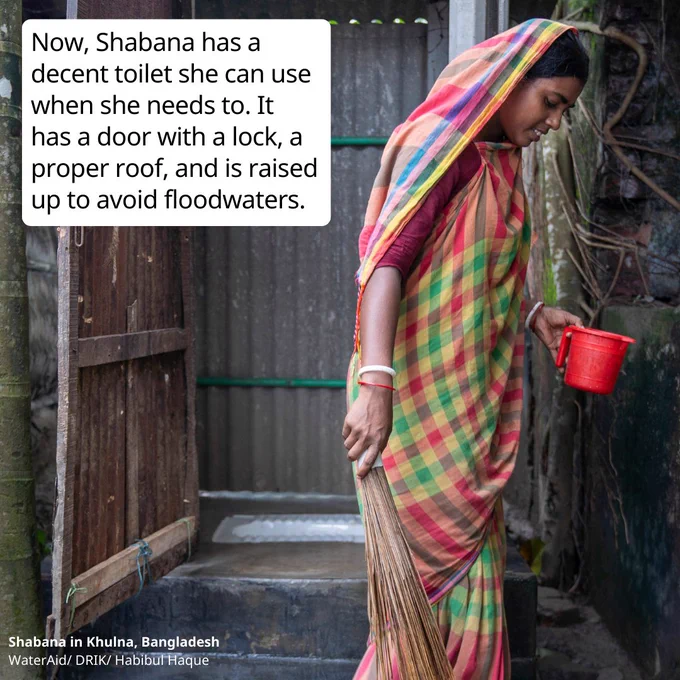 A photo of the same woman Shabana in front of a toilet with a roof. She carries a small red jug in her hand. Text reads: Now, Shabana has a decent toilet she can use when she needs to. It has a door with a lock, a proper roof, and is raised  up to avoid floodwaters.