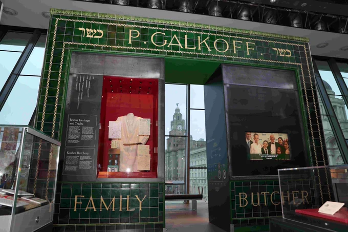 A replica of Galkoff's Butchers stands in Museum of Liverpool's People's Republic Gallery. 

The Green tiled shop front frames the Liver Building, which can be seen in the background.