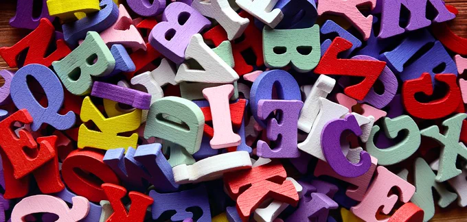 A jumble of brightly painted wooden letters.