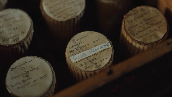 A photograph of a collection of wax cylinder recordings, one is labelled as a conversation between Robert Browning and Edison.