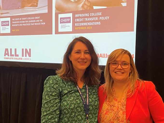 Two women in front of slide deck.