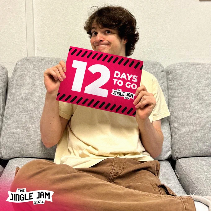 A young man (Tubbo) with brown hair sits on a grey couch, smiling sheepishly and holding up a sign to the camera. The sign is red and reads '12 days to go' and features the Jingle Jam logo. The 2024 Jingle Jam logo is also featured at the bottom of the image.