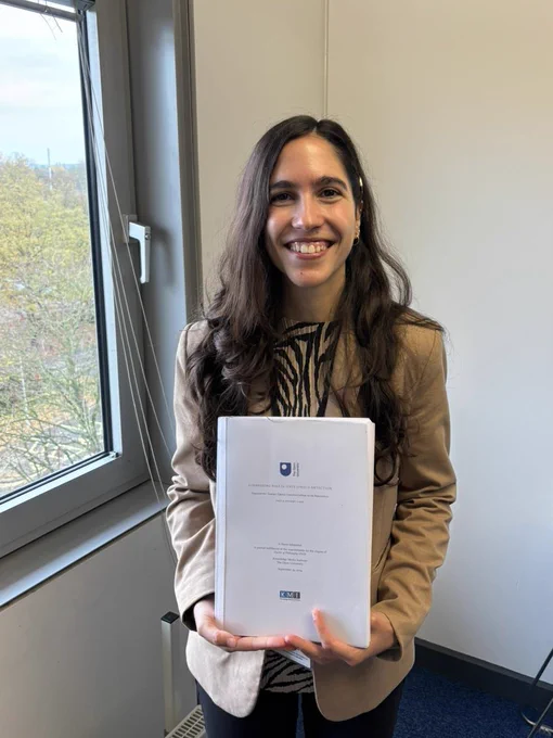 Me holding my thesis on “Addressing Bias in Hate Speech Detection: Enhancing Target Group Identification with Semantics”.