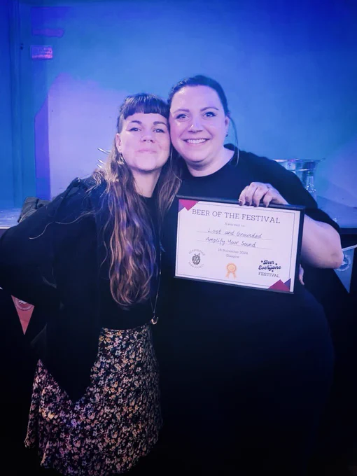 Two of our crew at the Beer is for Everyone Festival after winning Beer of the Festival - they are holding up their certificate for the photo.