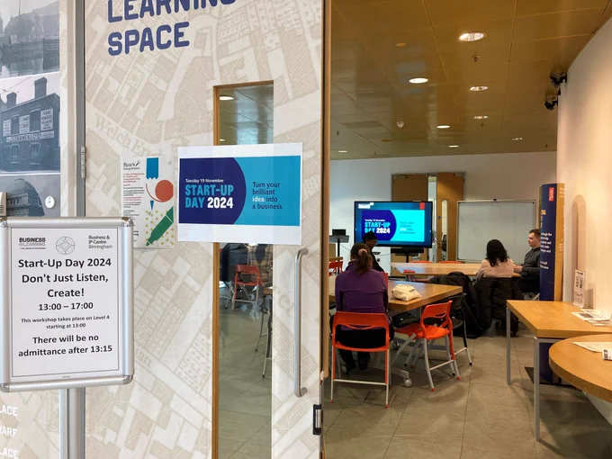 A photo of the host room for Start Up day 2024 prominently displaying the branding and welcoming poster.