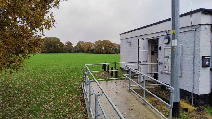 The outside of the Hackspace showing the entry ramp and leaves fallen on the field.