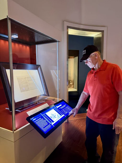 A man viewing the Gettysburg Address and reading information on the touch screen.