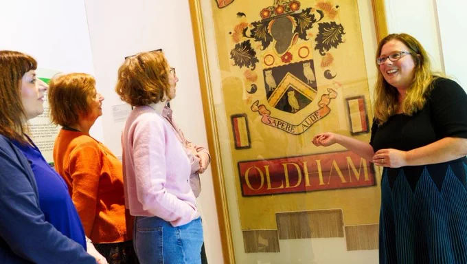 Curator Karen Heatley delivering a talk in front of a banner