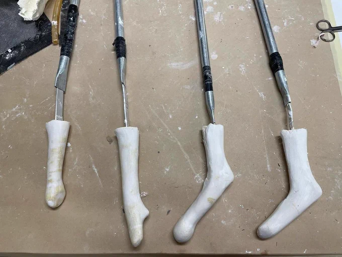 The molds for Zoe’s prosthetics sit on a table in a neat row.