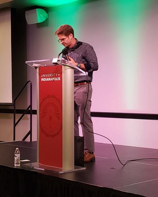 Prof Barney Haney speaking at a podium 