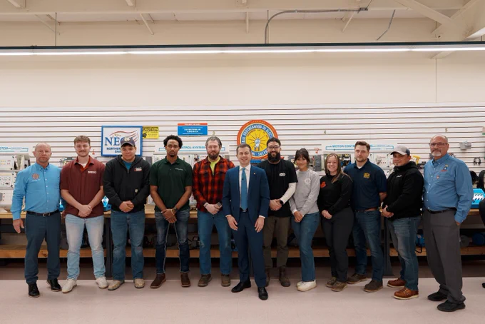 Group photo of Secretary Pete and apprentices at an IBEW Training Facility. 