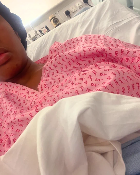 Toyin in a hospital bed. 
