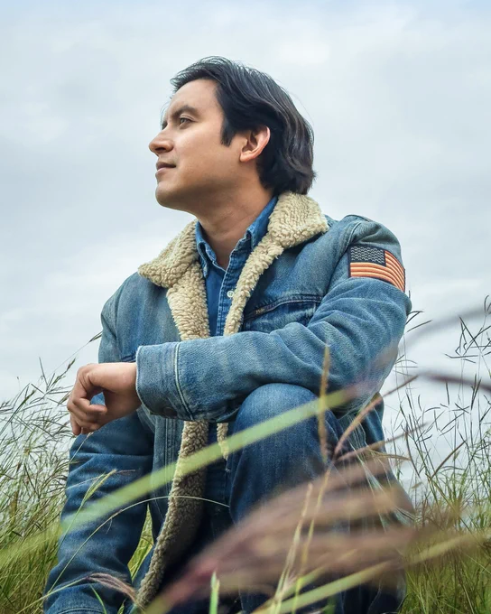 Joe Steven wearing a denim fleece jacket in an open field.