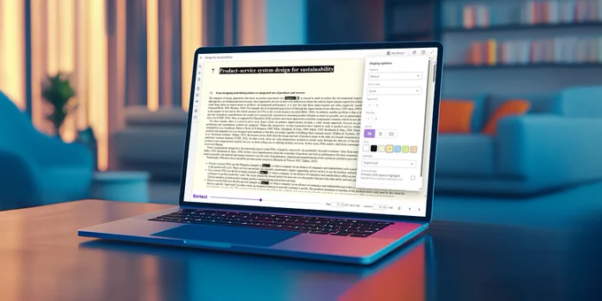 Image shows a open laptop with an eBook and the display options menu in Kortext study on screen. The laptop is set against a colourful living room background. 