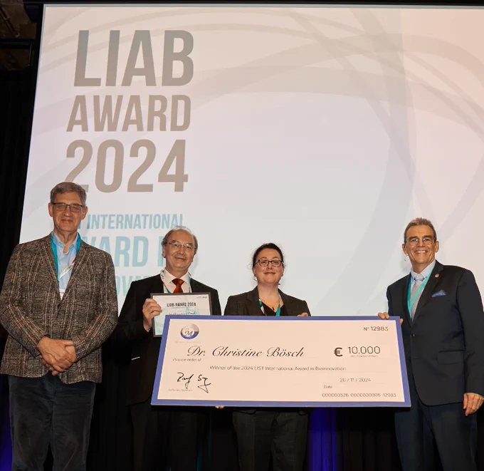 Dr Christine Bösch on stage, receiving the LIAB Award 2024.