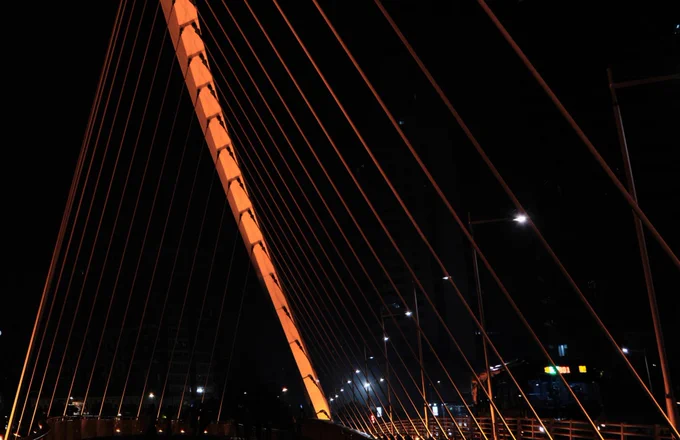 Picture of a bridge at night. Picture from Willem Chan on Unsplash.