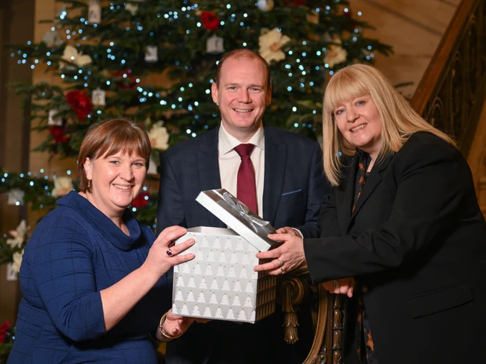 Communities Minister Gordon Lyons with Nicole Lappin from the Northern Ireland Housing Executive and Nicola McCrudden from Homeless Connect.