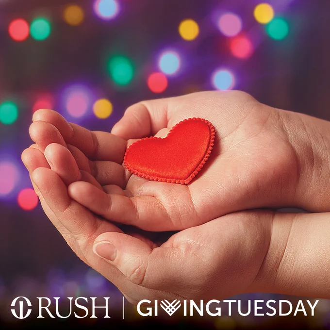 Giving Tuesday at Rush: A red heart-shaped item in open hands, with holiday lights in the background.