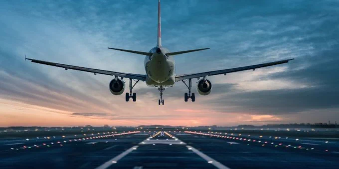 Plane taking off into the sunset.