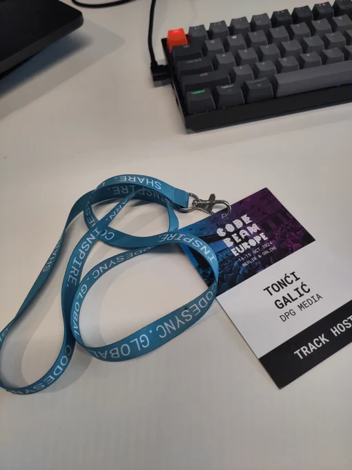 A green/blue lanyard from CodeBEAM Europe conference