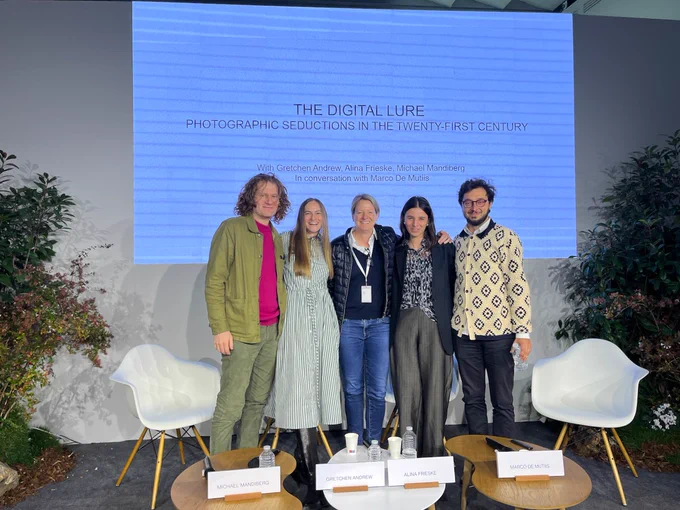 Five people standing in a row, after a panel conversation has happened. 
