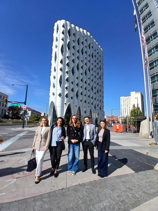 Participants of the International Visitor Leadership Program from Kosovo take a photo in front of the Populus Hotel in Denver, Colorado.