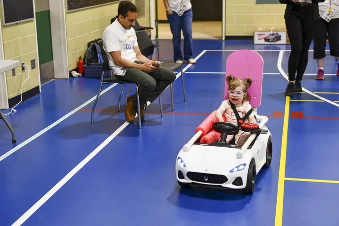 Child driving toy car.