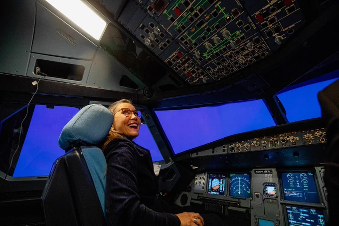 Salt Lake City Mayor Erin Mendenhall flies a plane in a simulator during the grand opening of Delta’s new pilot training center. 