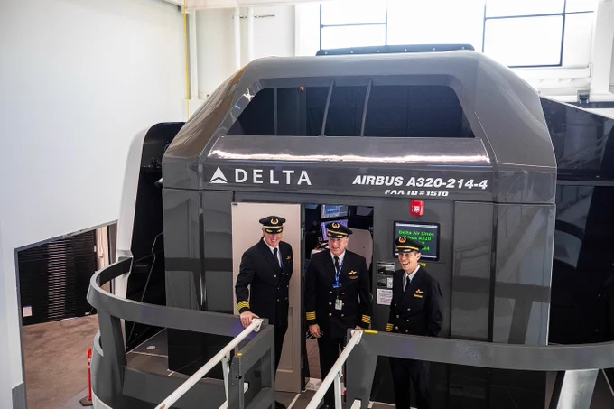 Three Delta pilots wait outside a flight simulator at Delta’s new pilot training center.