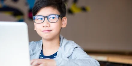 Boy at computer reflecting on his reactions to text. 