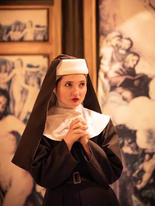 Ruby Benttal as Helen in All's Well that Ends Well (2024/5). 

An actress performs on stage in the Sam Wanamaker Playhouse. She is dressed as a nun. 
