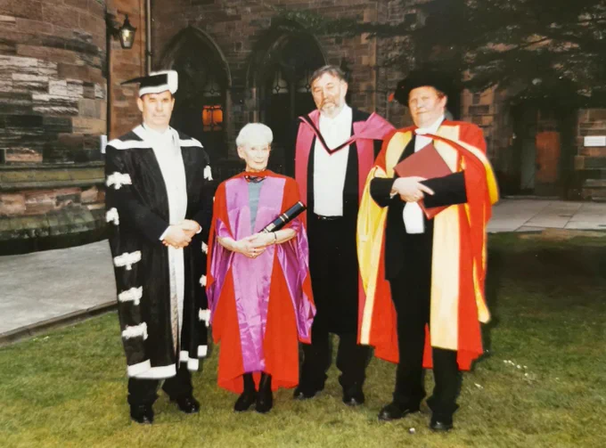 Bet Low with members of the senate of Glasgow University on the day of her award of the honorary degree of Doctor of Letters from Glasgow University in July 1999. Bet proudly holds her honorary degree recorded in a paper certificate and rolled up in a Glasgow University embellished cardboard tube.