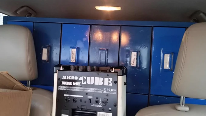 One of two blue metal cabinets shoved into the back of a Toyota Prius, as seen from the front seat.