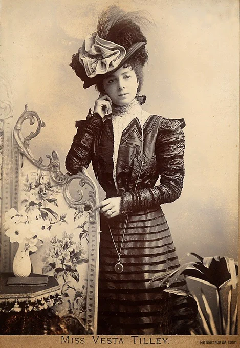 Black and white photo of Vesta Tilley as a young lady in an elegant dress ref 899.1400 BA1380