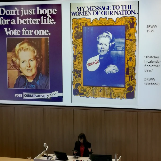 Irene Valenti in front of her presentation of 2 posters depicting Thatcher, one satirically
