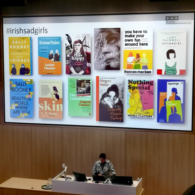 Dilâra Yilmaz in front of her presentation showing the covers of Irish #sadgirlbooks 