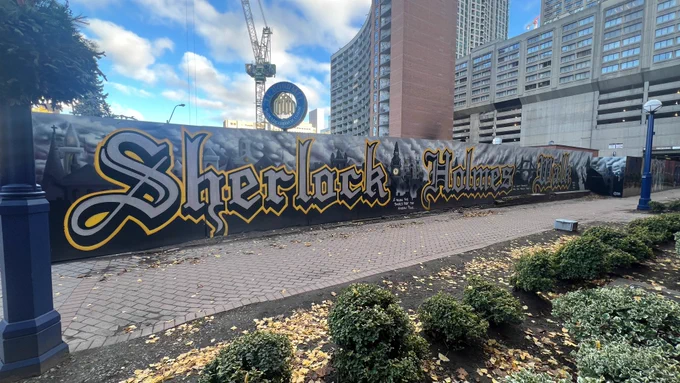 Long outdoor mural reading Sherlock Holmes Walk