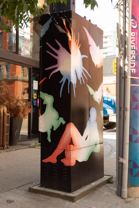 A human form reclines amongst floating visuals including dogs, a bird, moths, a milkweed pod and a snake. All forms are awash in gradients of purple, blue, green and red. The negative space around these forms is solid black.
