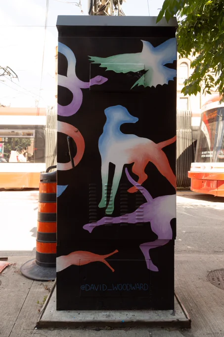 A human form reclines amongst floating visuals including dogs, a bird, moths, a milkweed pod and a snake. All forms are awash in gradients of purple, blue, green and red. The negative space around these forms is solid black.