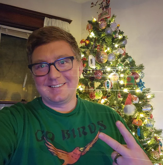 Selfie with an Xmas try behind me and "Go Birds" shirt with a Birds of Paradise from mtg card on it. 