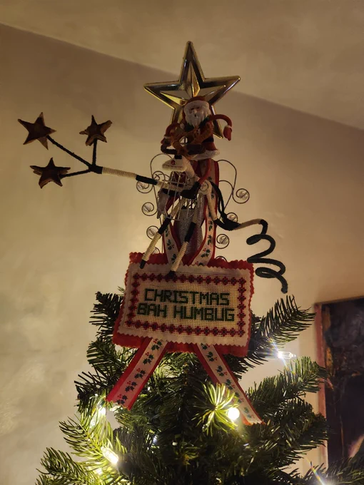The star on our tree is a mash in of a star over a wire Angel holding a Rudolph holding 3 other star with an abnormally long arm that Santa is riding 